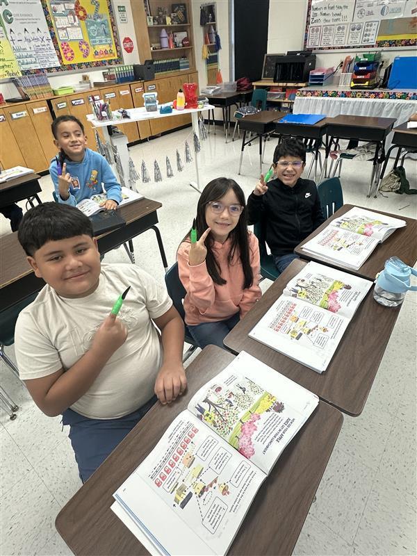 Kids reading by pointing with spooky finger.