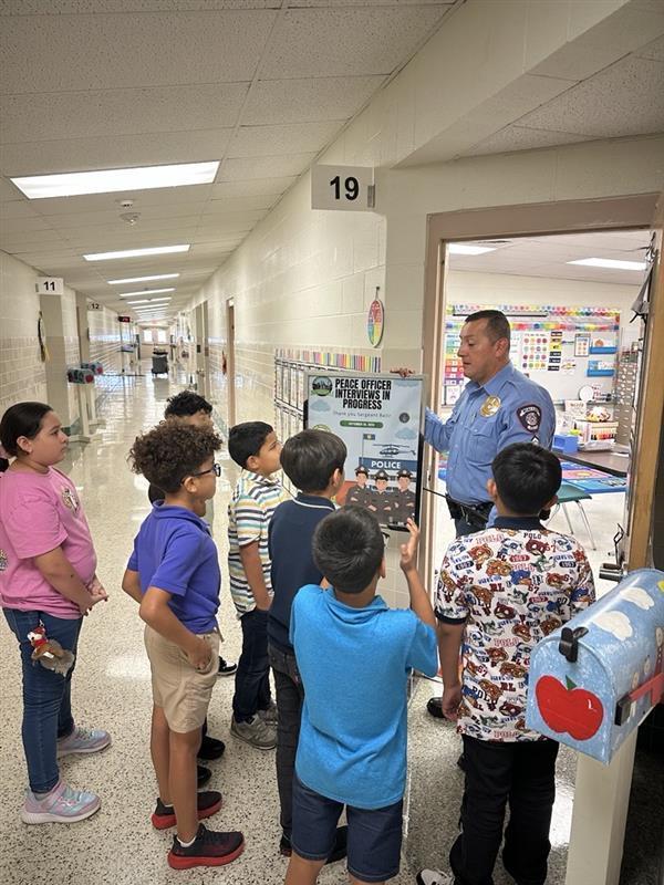 Sgt. Balli talking to kids.