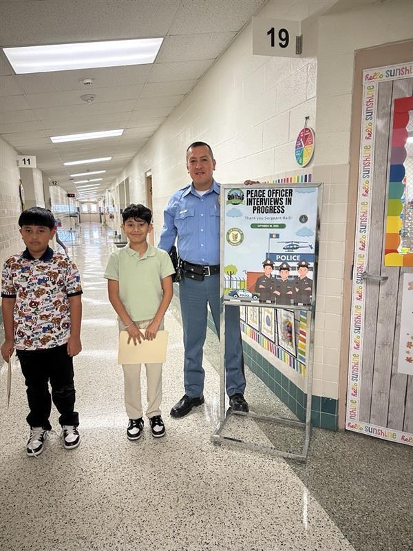 Kids posing with Sgt. Balli.
