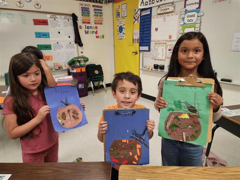 Kids posing with their nest.