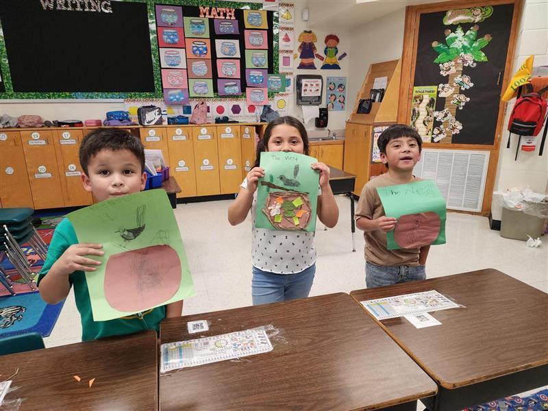 Kids posing with their nest.