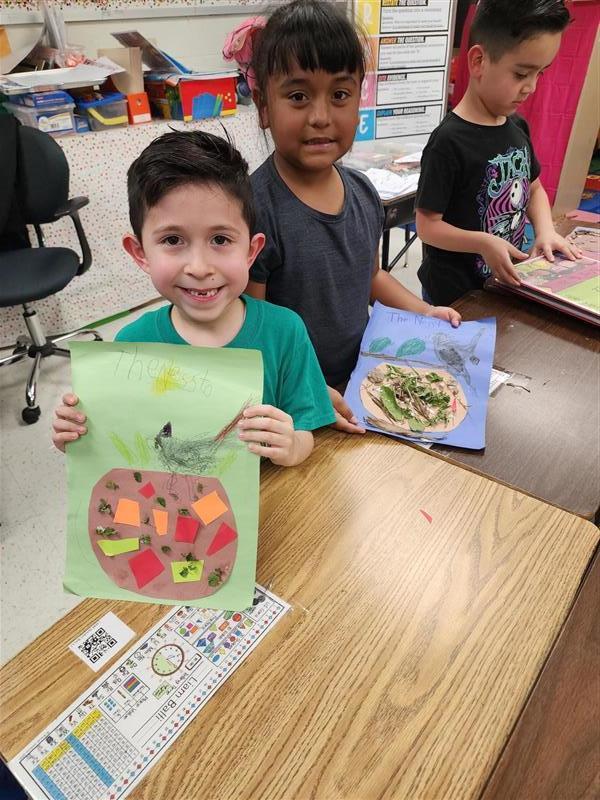 Kids posing with their nest.