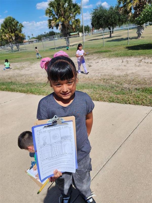 Student posing with clipboard.