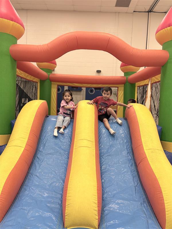 Students posing at a slide.