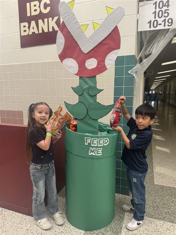 Students feeding the piranha plant.