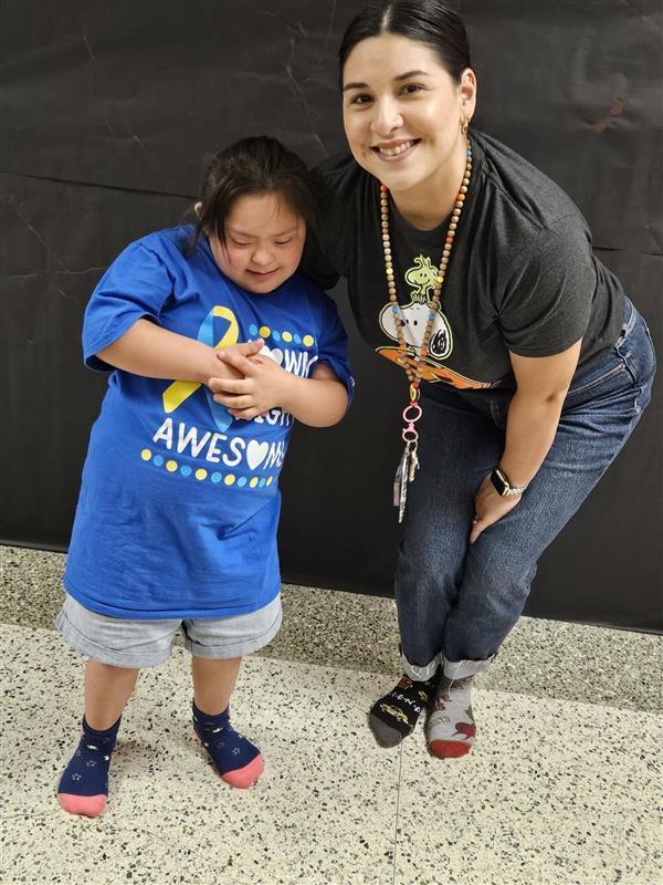Kid and teacher rocking their socks.