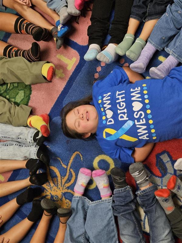 Picture of student socks with a student in the middle.