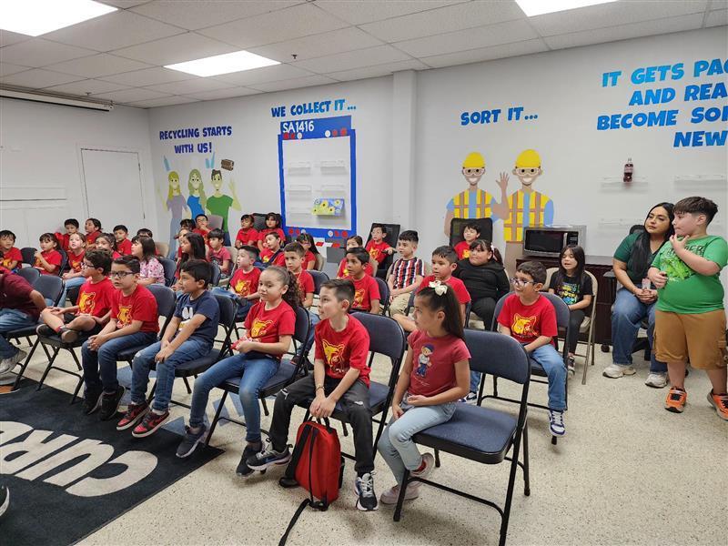 Kids posing in front of the recycling center.