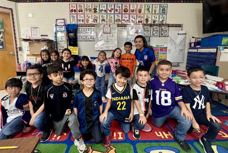 Kids posing with team jersey for Red Ribbon Week.