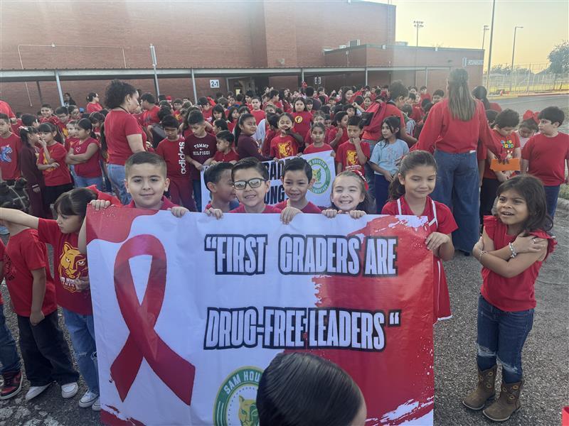 Kids posing with banner.