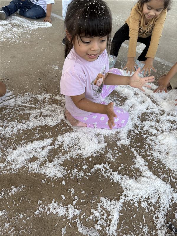 Student playing with snow.