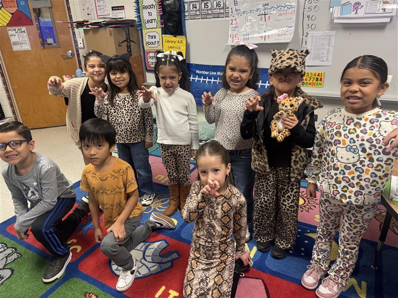 Kids posing wearing animal print.