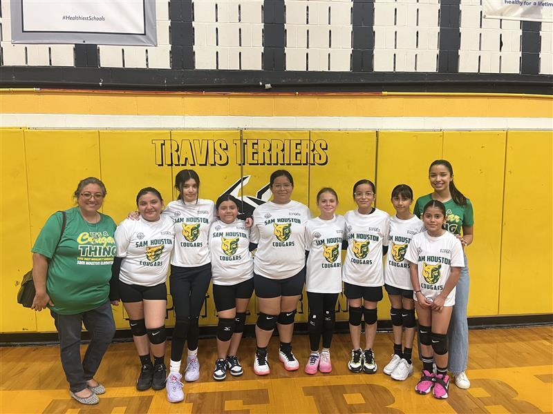 Volleyball team posing with teachers.