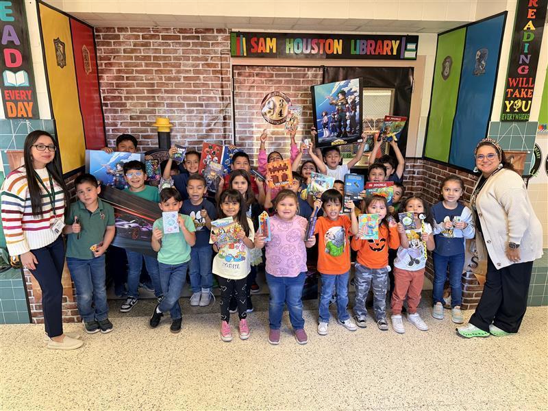 Raffle winners posing with counselor and librarian.