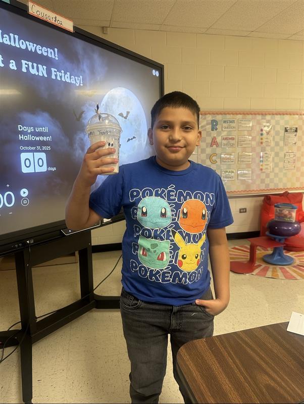 Student posing with treat.