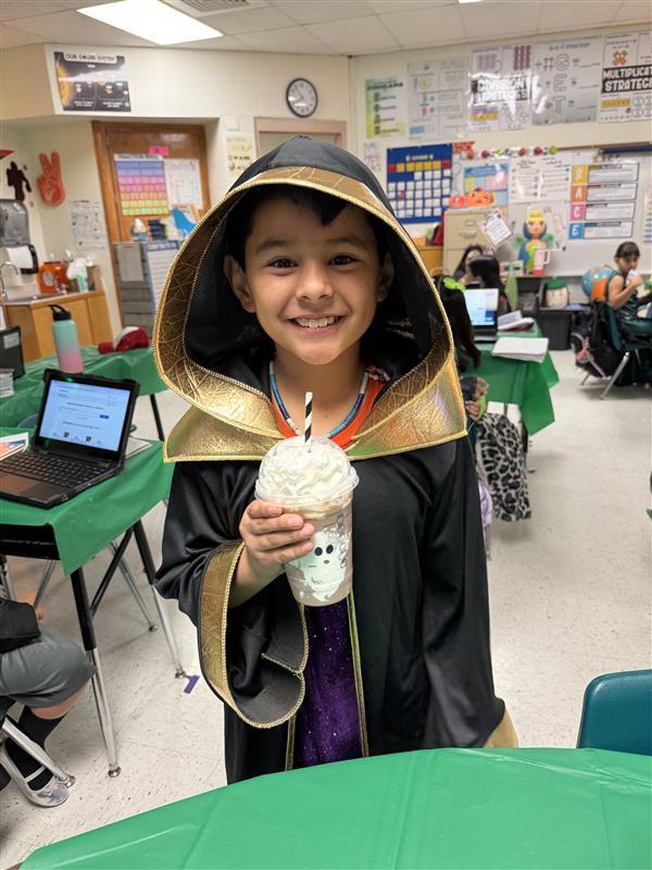 Student posing with treat.