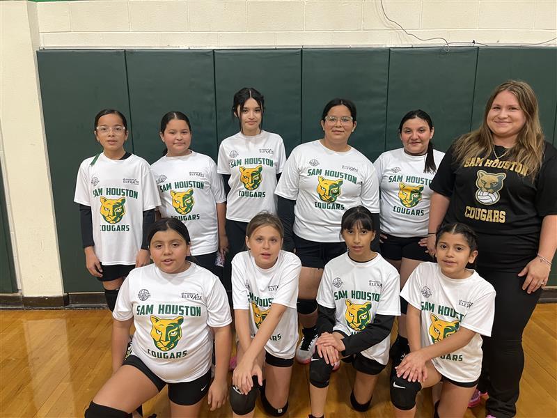 Volleyball team posing with Coach.