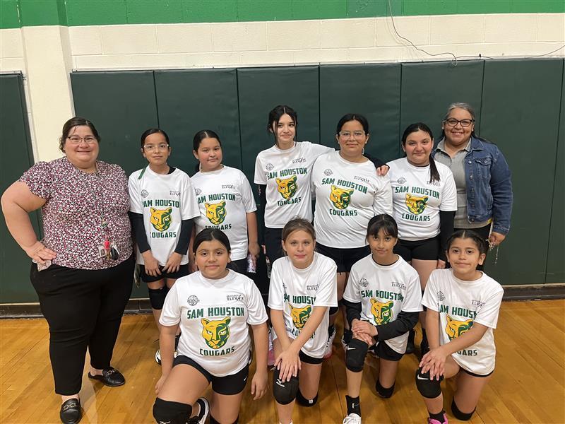 Volleyball team posing with teachers.