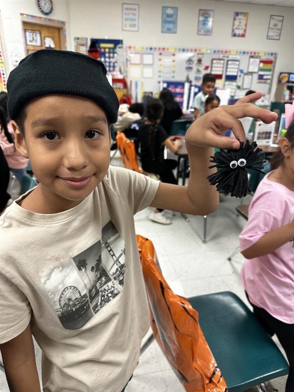 Student posing with worry monster.