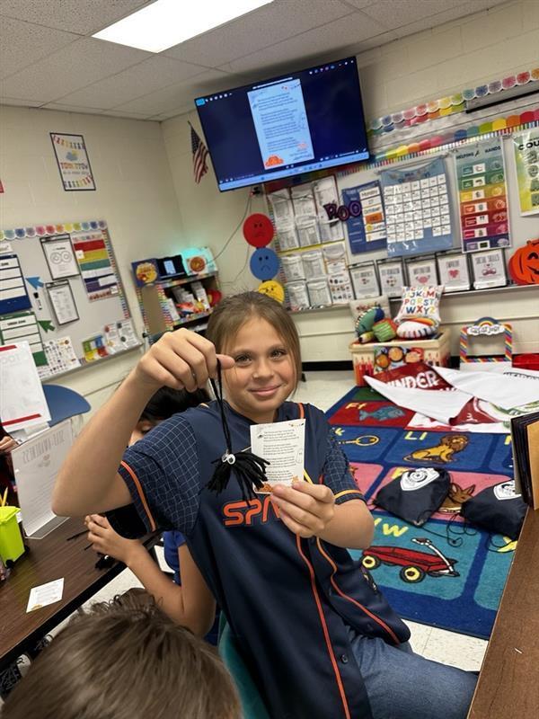 Student posing with worry monster.