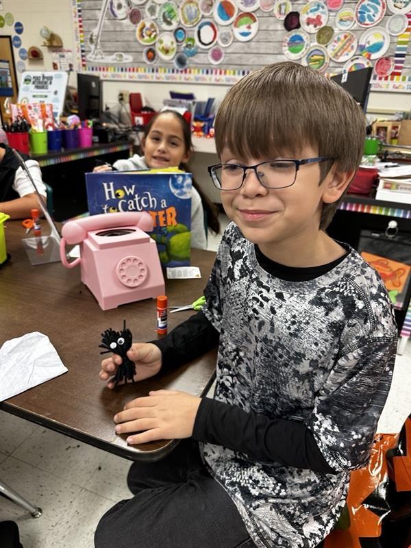 Student posing with worry monster.