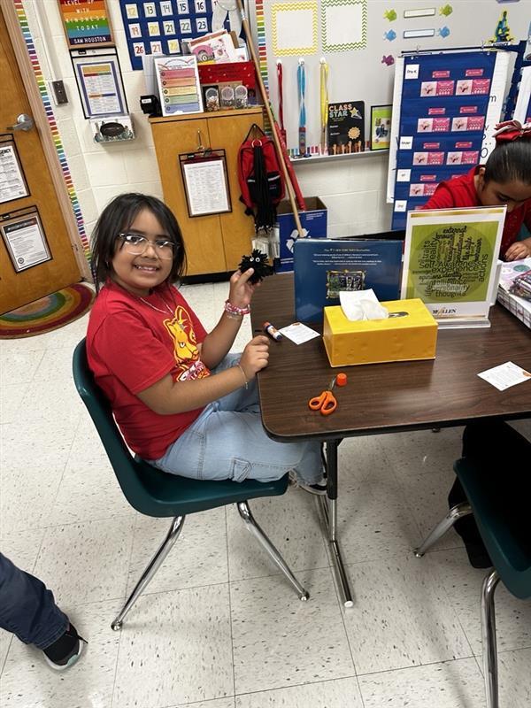 Student posing with worry monster.