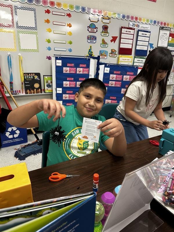Student posing with worry monster.