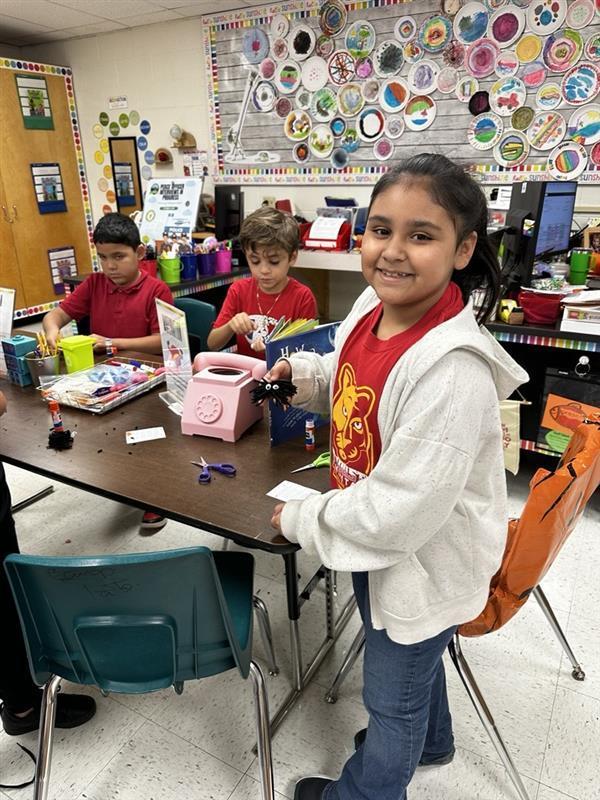 Student posing with worry monster.