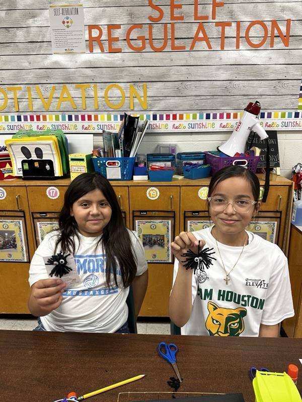 Student posing with worry monster.