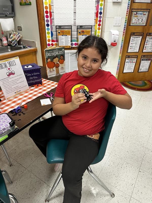 Student posing with worry monster.
