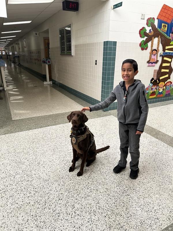 Student posing with K9.