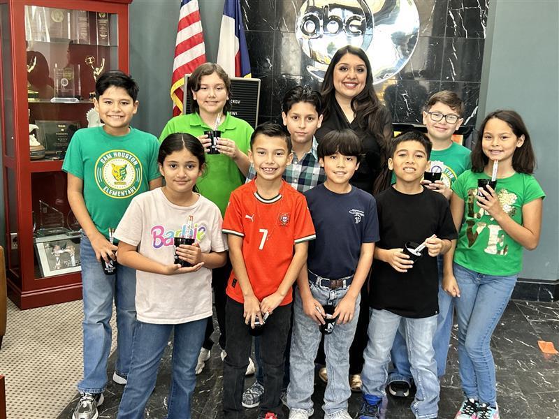 Students posing outside the KRGV Newsroom.