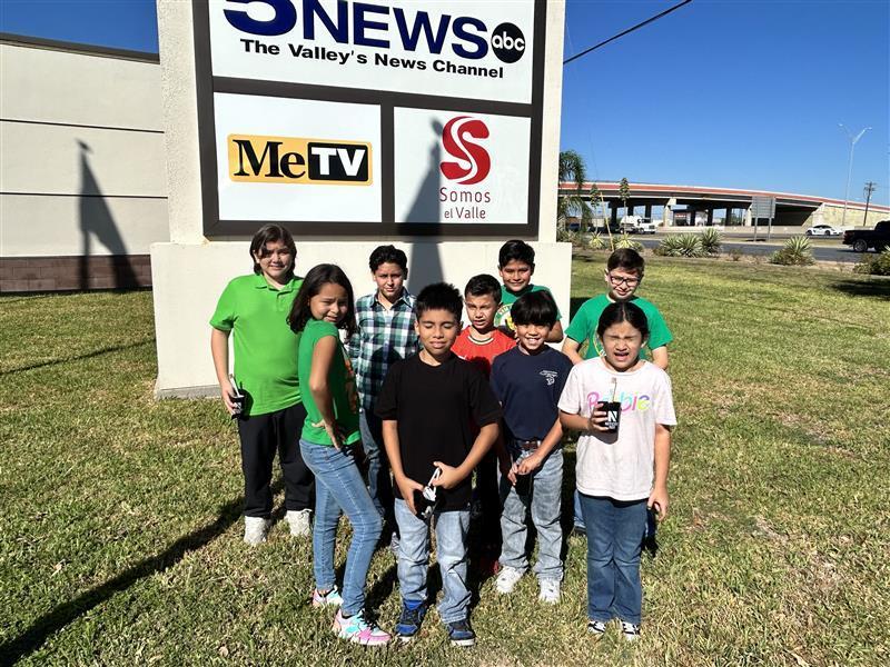 Students posing outside the KRGV Newsroom.