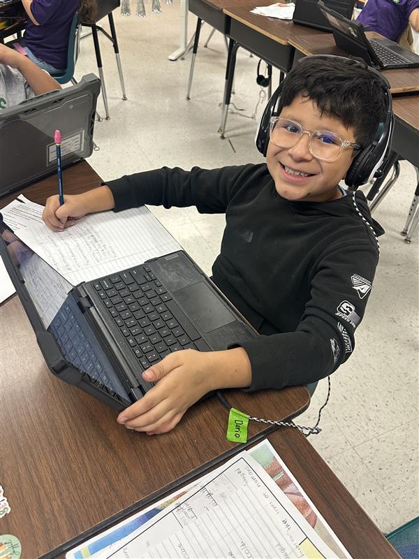 Kids posing while they work on their extended constructed response.