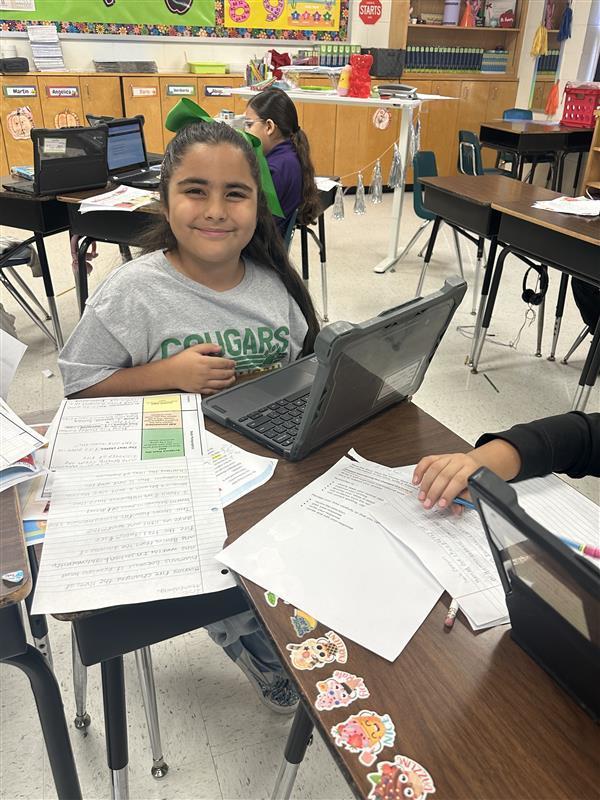 Kids posing while they work on their extended constructed response.