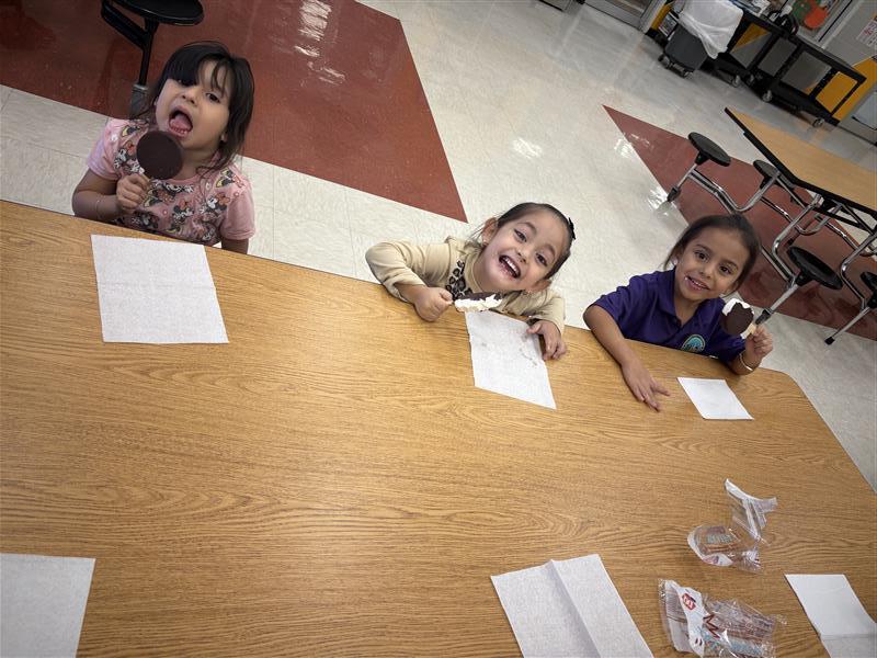 Kids posing eating dilly bar.