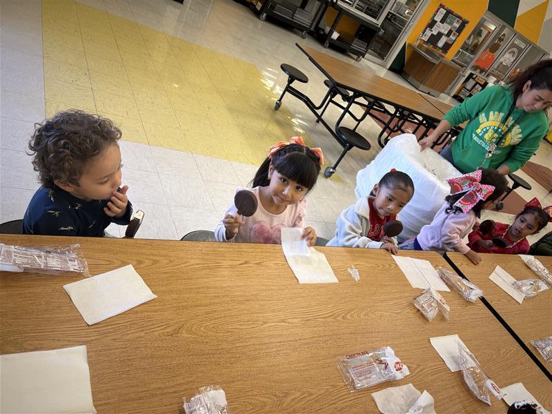 Kids posing eating dilly bar.