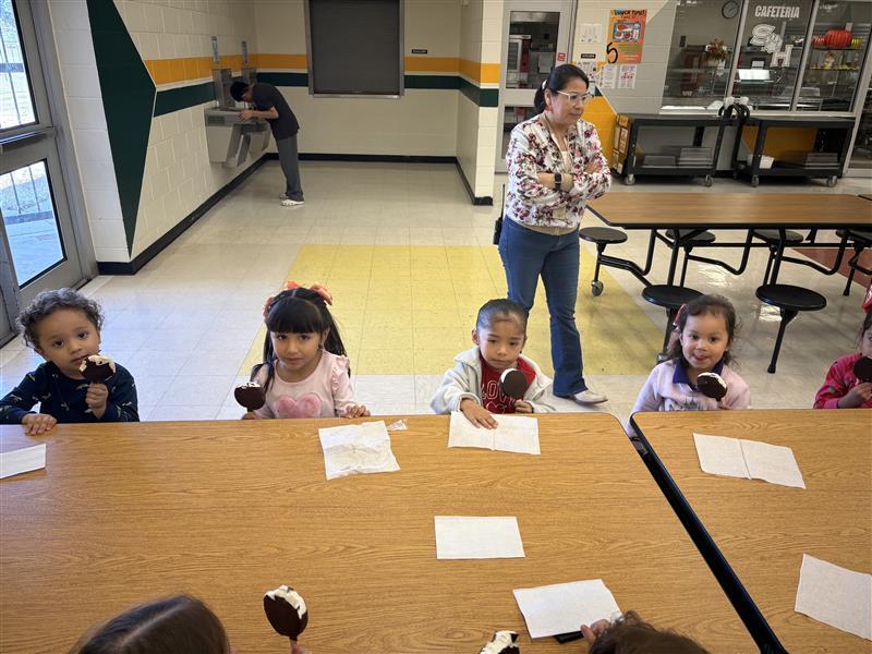 Kids posing eating dilly bar.