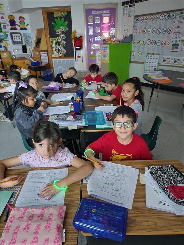 Kids posing with their glow in the dark bracelet.