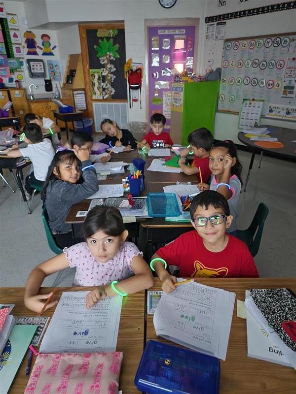 Kids posing with their glow in the dark bracelet.