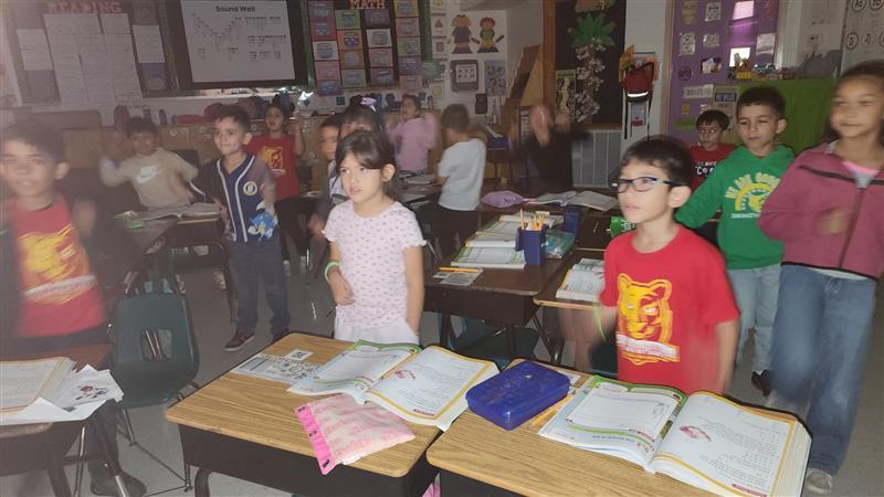 Kids posing with their glow in the dark bracelet.