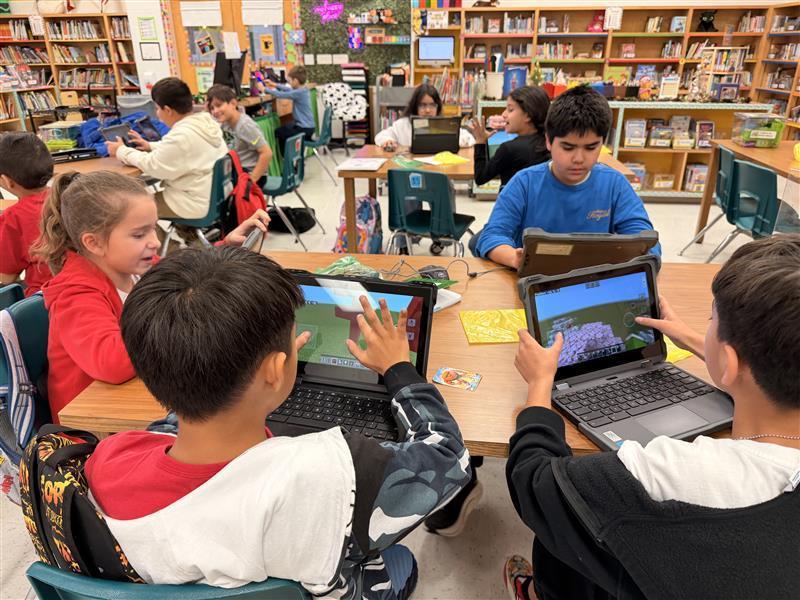 Kids working on Minecraft tasks for Esports.