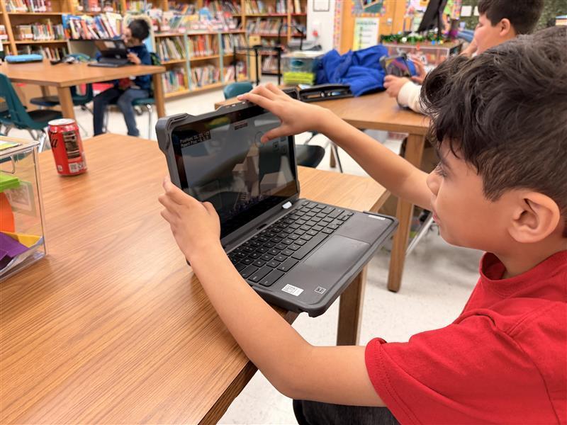 Kids working on Minecraft tasks for Esports.