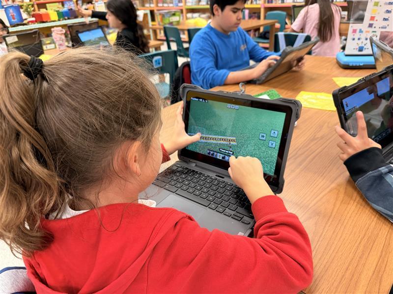 Kids working on Minecraft tasks for Esports.