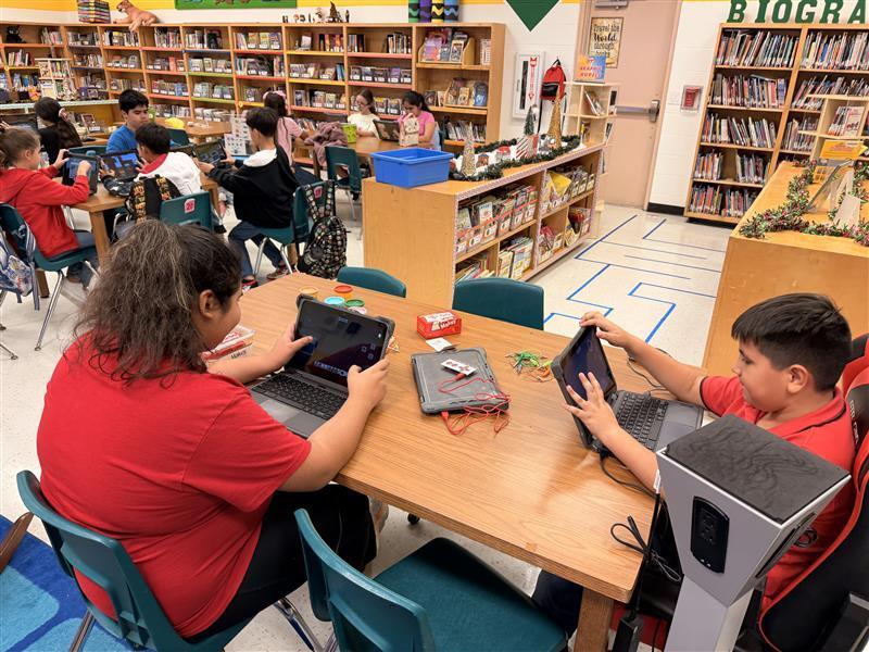 Kids working on Minecraft tasks for Esports.