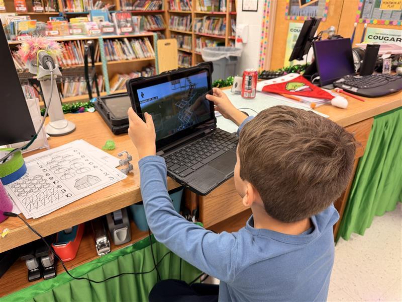 Kids working on Minecraft tasks for Esports.