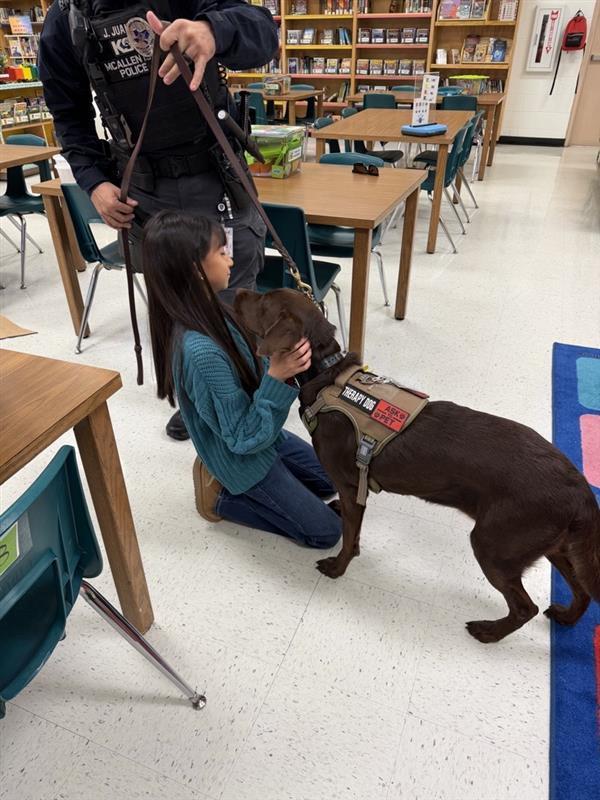 Students handling emotional support K9 officer.