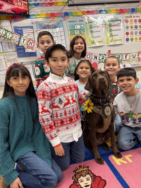 Students posing with emotional support K9 officer.