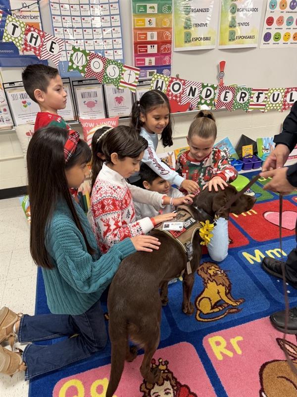 Students petting emotional support K9 officer.
