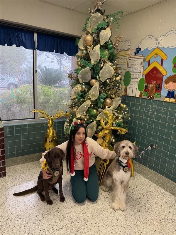 Counselor posing with emotional support K9 officers.